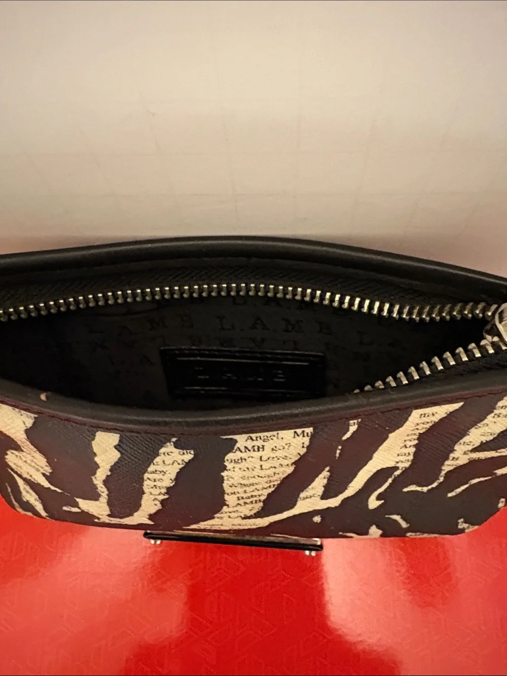 L.A.M.B. Black and Cream Zebra-Print Clutch with Logo Plate